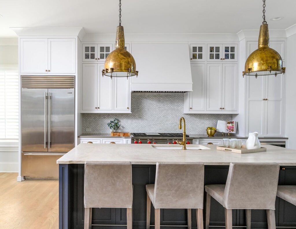 Kitchen with white cabinets and antique brass pendant lights