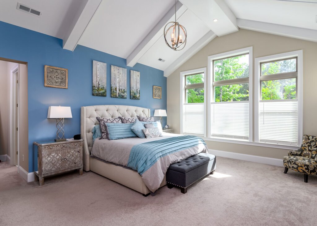 Primary bedroom with a vaulted beamed ceiling