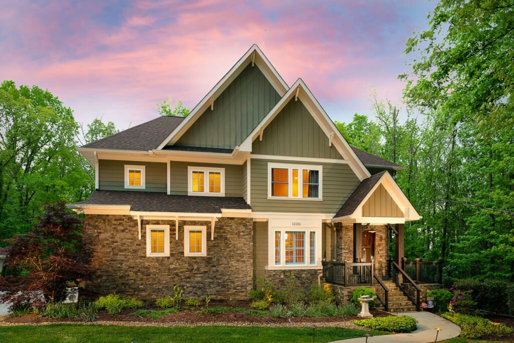 Craftsman home with a stone base photographed at twilight