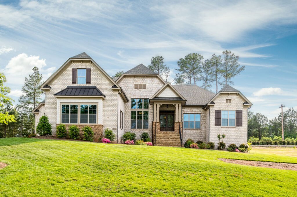 White brick craftsman home photographed in daylight